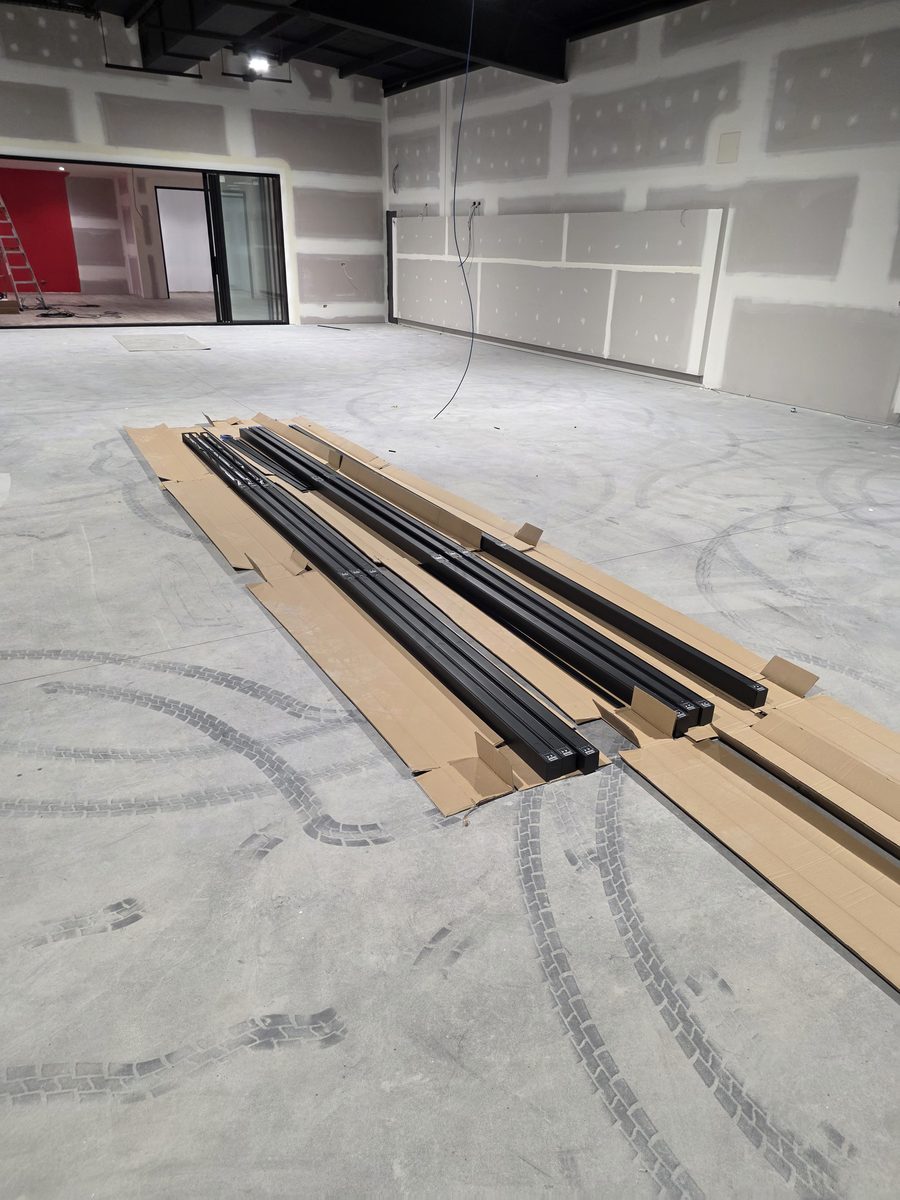 Before fit-off: linear light battens on the floor of the unfinished tenancy